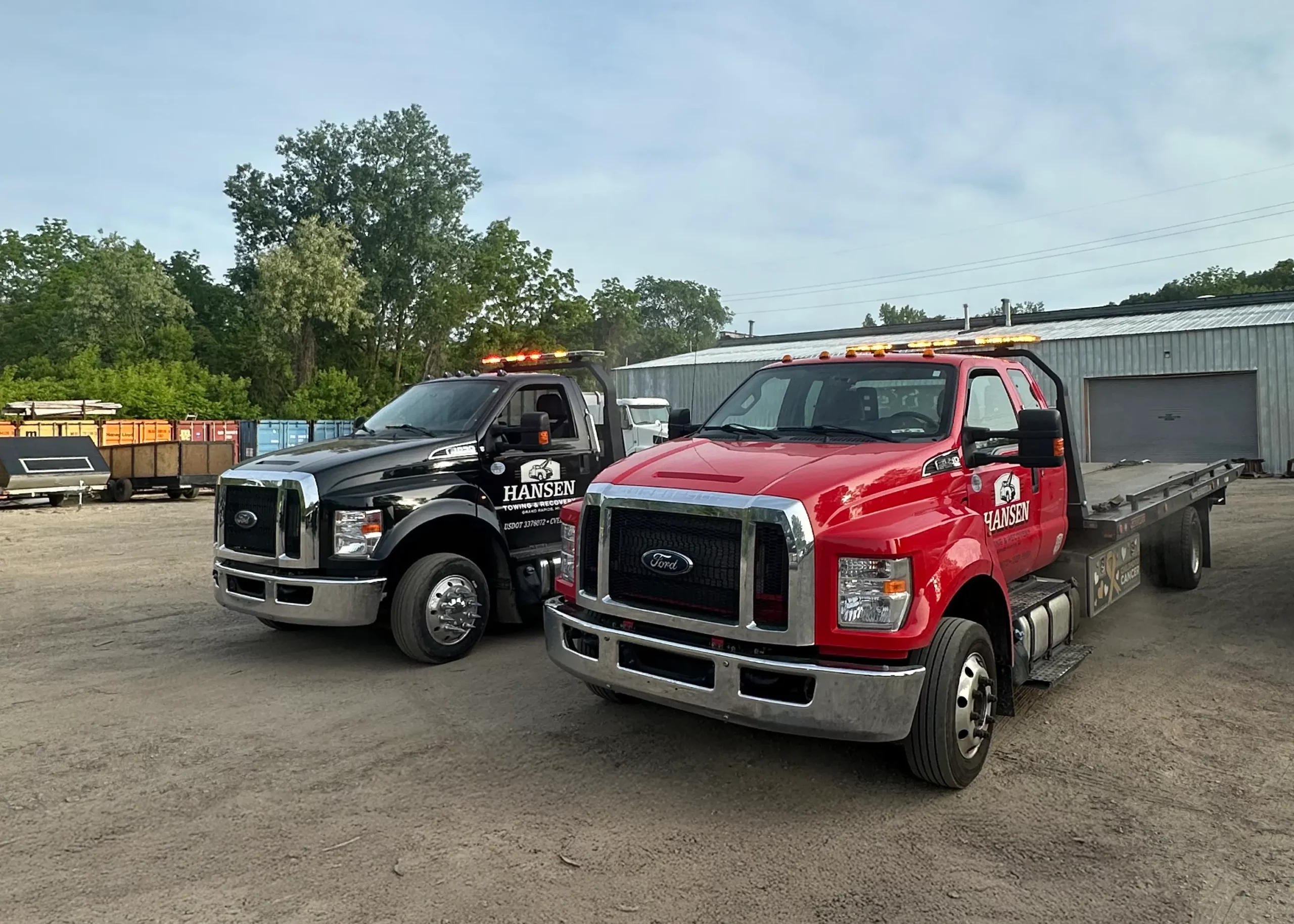 Red and black Hansen Towing flat bed tow trucks in Grand Rapids, MI